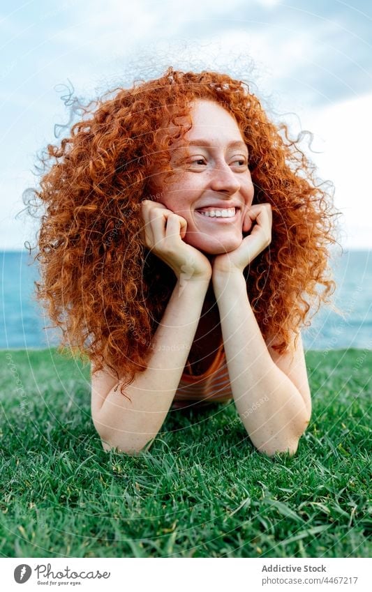 Cheerful Ginger Haired Woman Lying On Grass A Royalty Free Stock