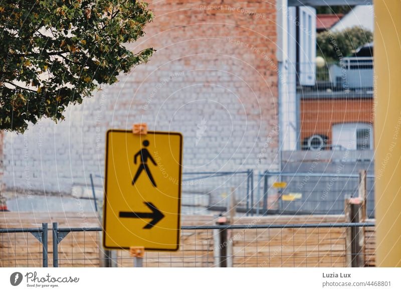 Pedestrians this way: signpost, autumnal foliage, facades and construction site grids create a harmonious picture Autumn Autumnal Signage Direction Yellow Red