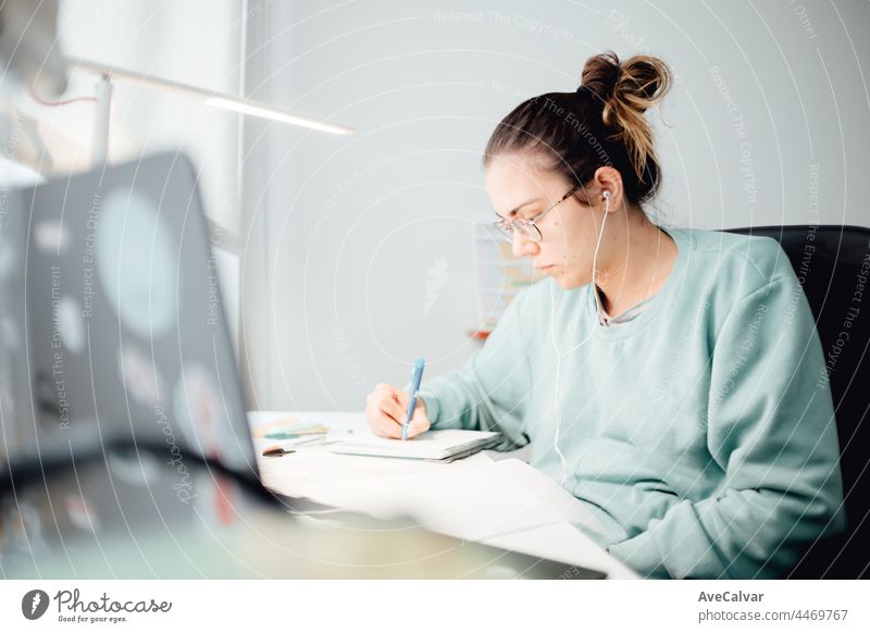 Girl working on laptop from home or student studying from home or freelancer. Online work, late night desk work, home office teenage person woman young