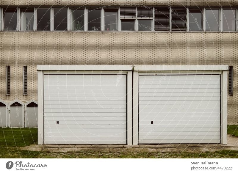 2 garages in front of a house wall Garage Garage door Gloomy Goal Deserted Closed Building Exterior shot Highway ramp (entrance) Old Retro Architecture