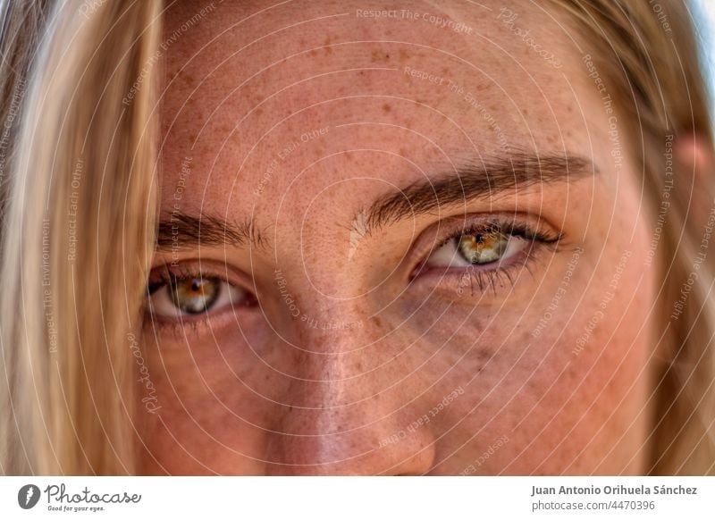 Beautiful woman girl looking at camera. close-up to very beautiful girl  with amazing green eyes