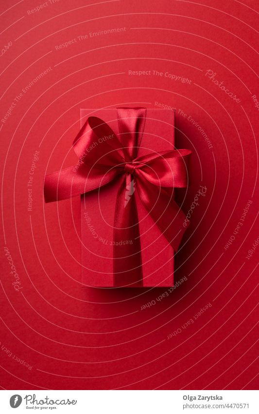 Red gift box on red background. valentine christmas monochrome minimal present top view ribbon premium luxury bow surprise color symbol holiday birthday love