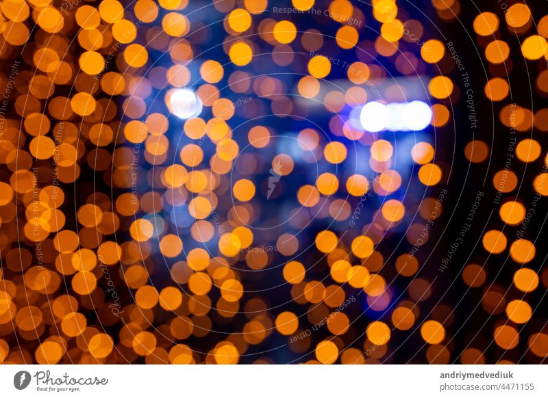 Abstract circular bokeh background of Christmaslight. bokeh from garlands. background for screensaver. Defocused lights. Blurred bokeh with yellow color lights.