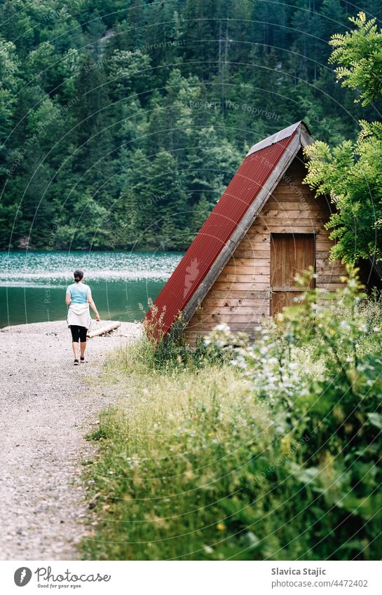 Young anonymous woman alone by the lake  between mountains Woman Lake Vacation & Travel Summer Green Calm Relaxation Water Mountain Trip vacation Tourism Nature
