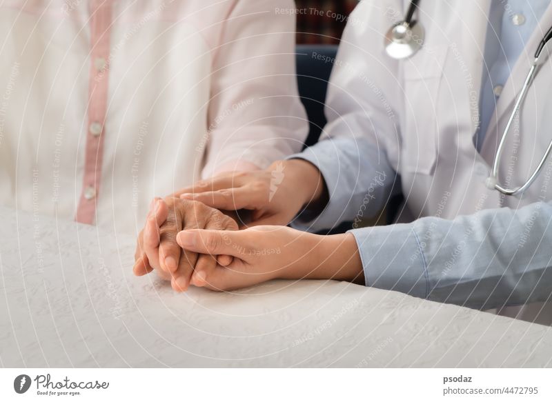 Doctor hands together holding senior woman patient addiction adult aged aid assistance care caucasian closeup communication compassion concept conceptual