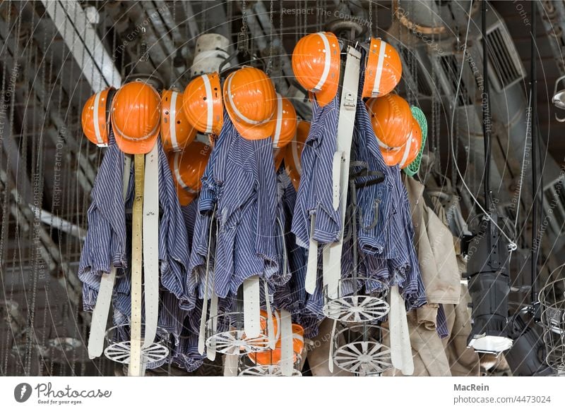 Miner's clothes in a washhouse under the ceiling Wachkaue Workwear Helmet Helmets Clothes baskets underground Coal Lignite Clothes peg Miner's clothing