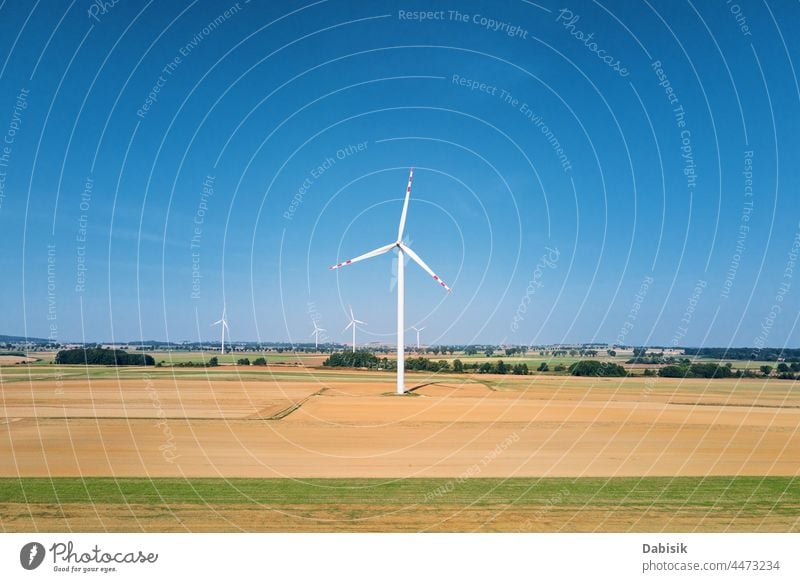 Windmill turbine in the field at summer day. Rotating wind generator energy windmill technology propeller sustainable landscape eco electric concept industry