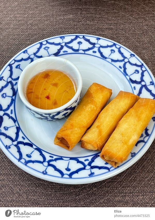 Three crispy spring rolls with sweet and sour sauce on a plate Spring roll Asian Crisp three Appetizer Delicious Plate