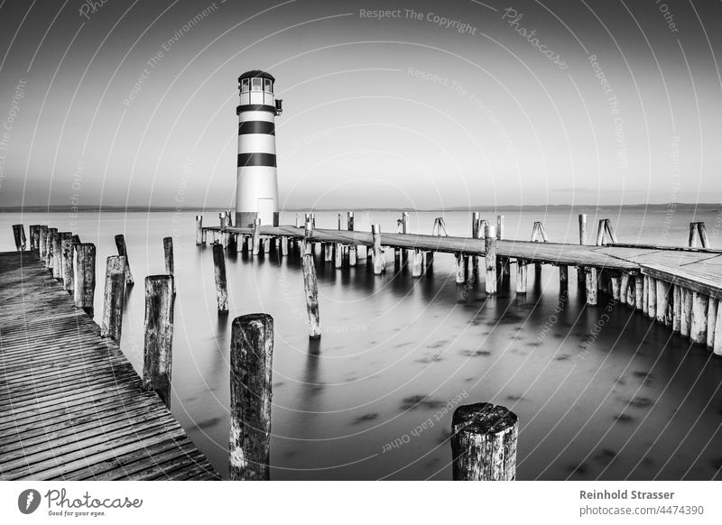 Lighthouse Podersdorf at sunrise Footbridge Water Lake Sunrise Black & white photo black-and-white B/W Ambience Landscape tranquillity Shadow certain light