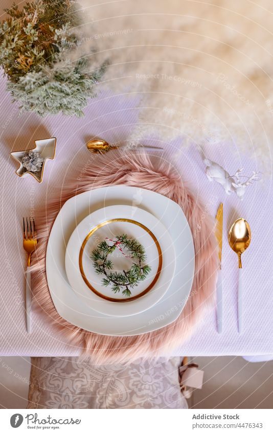 Pink christmas table setting with white and gold decorations red celebration thanksgiving holiday plate pine branch candle placemat fluffy cute fork cutlery