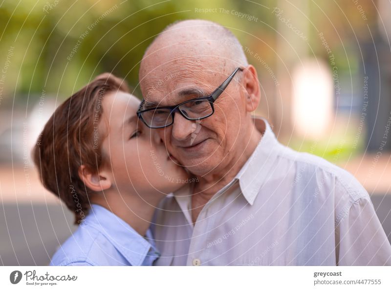 Grandpa is happy to feel the love from grandchild family grandson granddad grandfather kiss grandpa grandparent portrait old senior affection kid elderly boy
