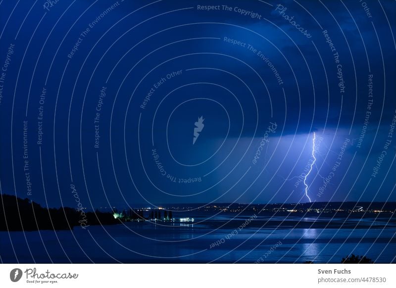 A thunderstorm over Lake Constance makes for a beautiful spectacle Thunder and lightning lightning bolt Clouds Water Gale Storm Idyll Nature captivating