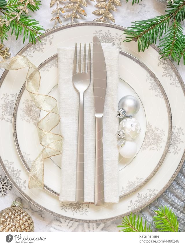 Festive table setting with fir tree branches and Christmas decorations christmas table place ornaments holiday new year marble white golden celebration
