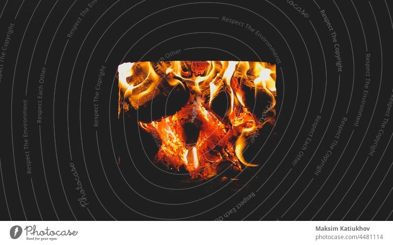 Burning firewood in the stove. flame in the fireplace burn bonfire warm yellow light red temperature background fuel black log blaze bright burnt campfire