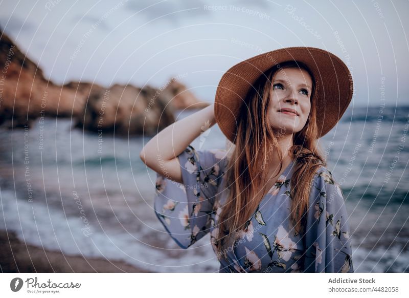 Woman in dress and hat woman evening sea seashore sunset summer delight happy female coast beach style joy trendy charming seaside smile nature seascape sundown