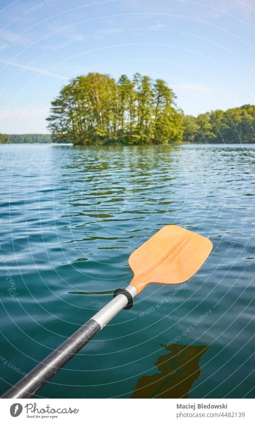 Kayak paddle over the water, ecotourism concept, selective focus. kayak sport nature canoe nobody adventure activity vacation oar equipment leisure journey