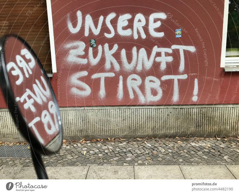 Reflection, graffiti on red house wall "Our future is dying!" / Photo: Alexander Hauk Graffiti Wall (barrier) Wall (building) Red Silver silver Art Street art