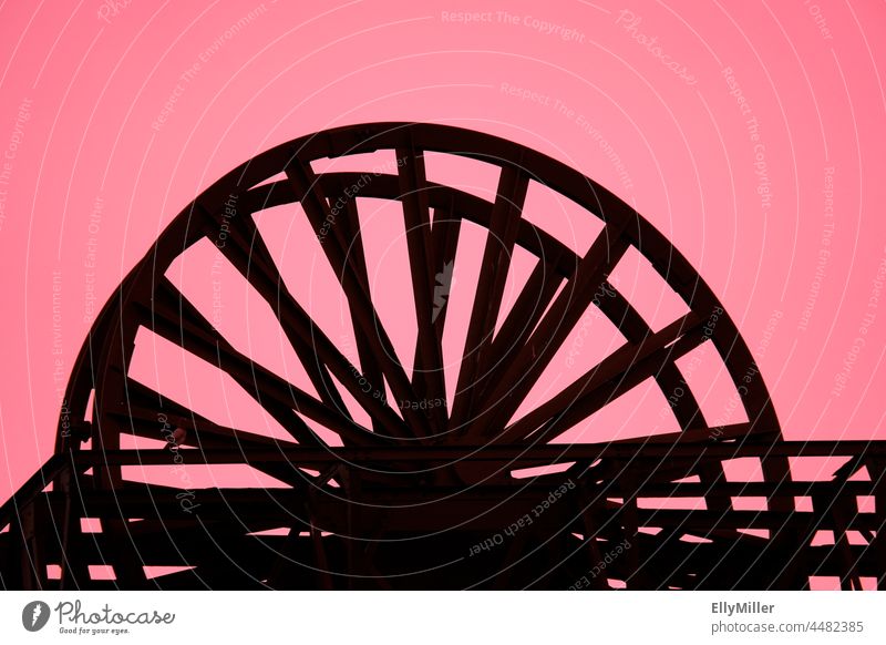 Abstract photograph of the Radbod colliery in Hamm. Black silhouette of a wheel against a pink background. Radbod Colliery Hamm Mine Industry Industrial plant