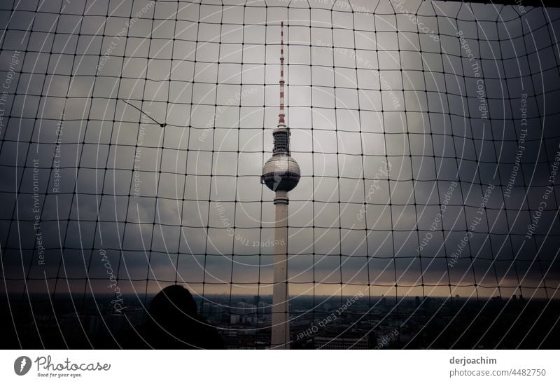 The Berlin TV tower from above, behind a safety net in very bad weather. The horizon can only be seen as a small ray of hope. Tower Landmark Sky Architecture