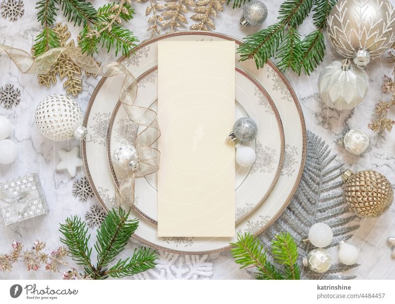 Festive table setting of with fir tree branches and Christmas decorations. Mockup christmas menu mockup card ornaments holiday new year celebration copy space