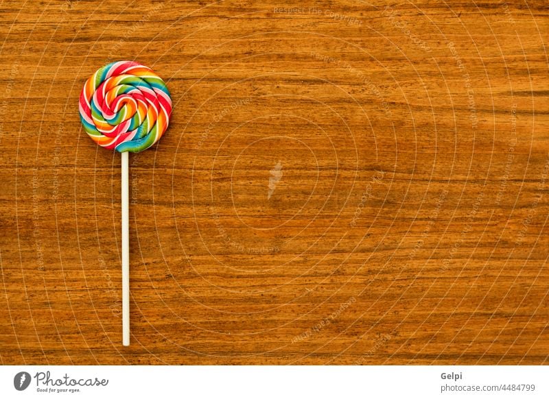 Nice lollipop with many colors candy food sweet lolly sugar white delicious colorful stick background dessert unhealthy red tasty swirl sucker spiral snack