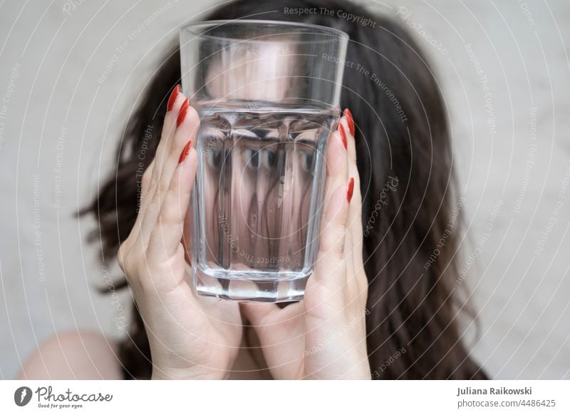 Woman looks through an empty glass Delicious To enjoy stop Transparent Brunette Empty Nutrition Thirsty Refreshment Drinking water Mineral water Close-up