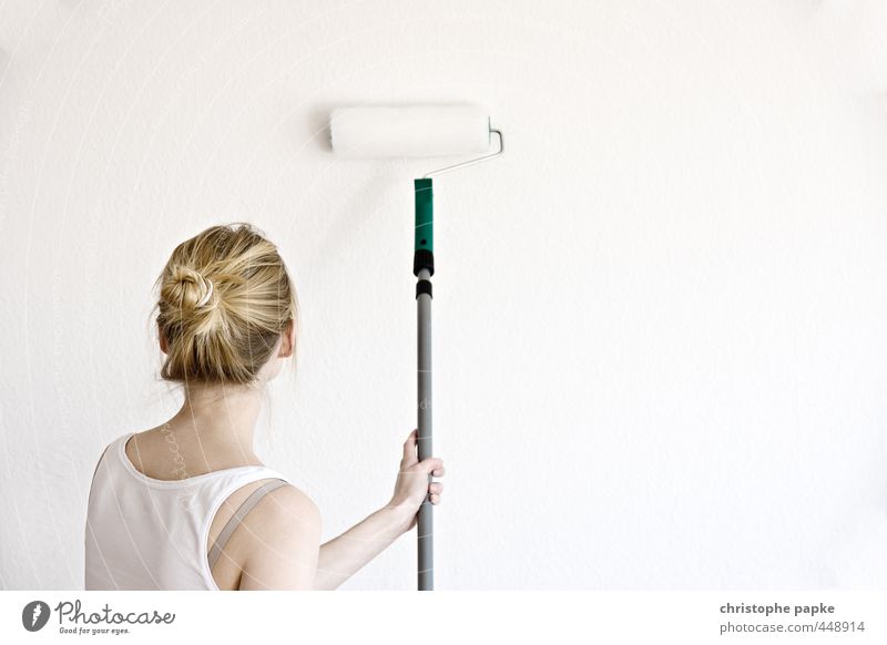 Blonde woman painting wall with roller Redecorate Moving (to change residence) Painting (action, work) string part Home improvement Flat (apartment) Wallpaper