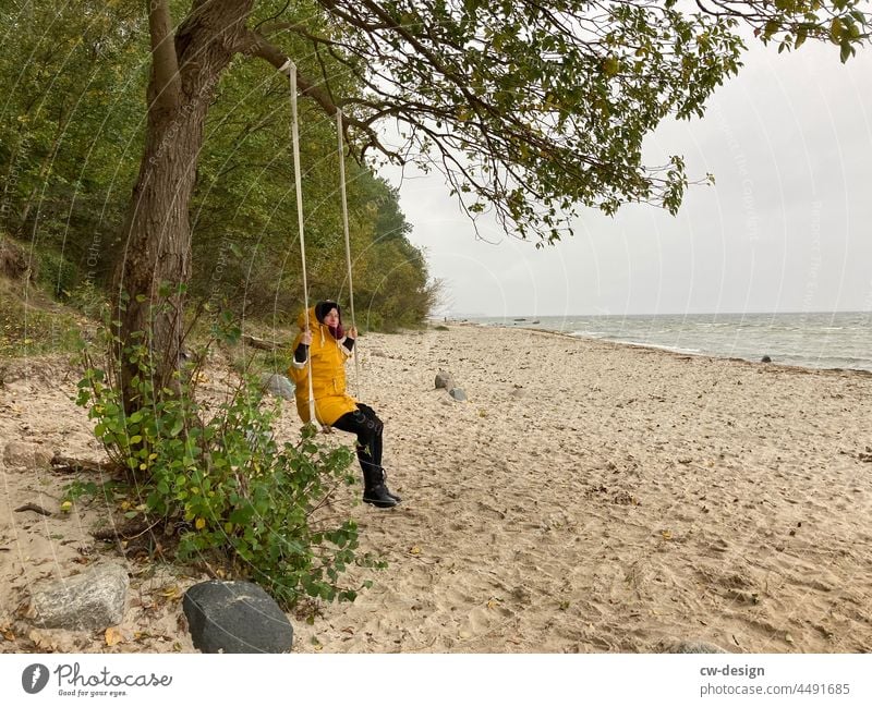 Woman on a swing on the beach Swing Beach Exterior shot Sand Ocean