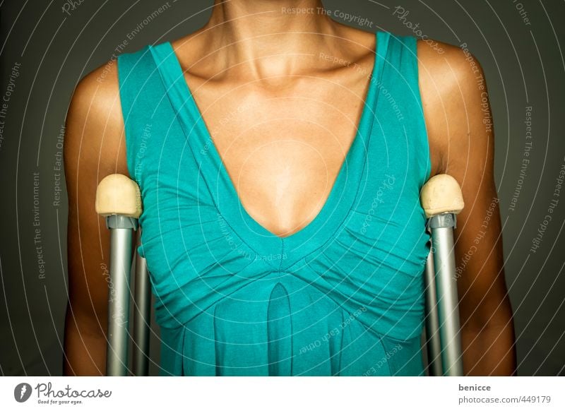 crutches Woman Human being Accident Walking aid Dress Green Blue Studio shot Breasts Upper body Fracture Handicapped Patient Hospital Insurance Risk of accident