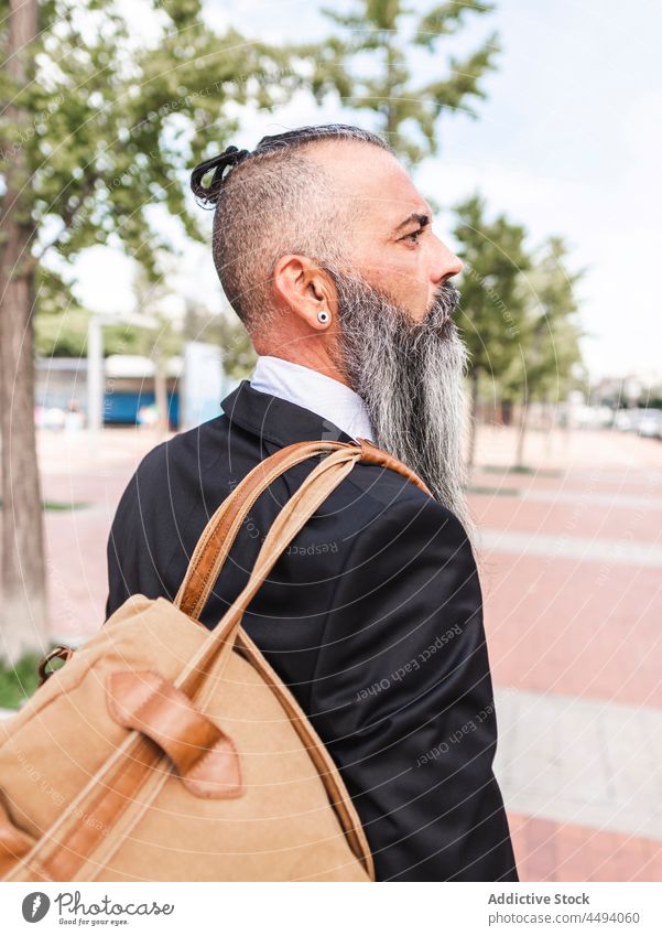 Hipster in classy wear standing on the street man hipster style formal city road urban trendy modern employee beard confident outfit male building thoughtful