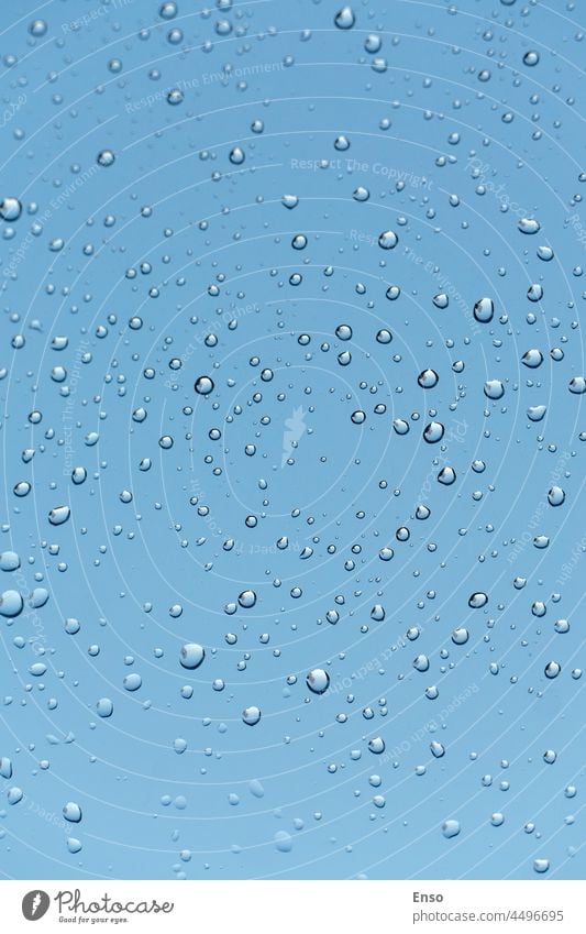 Raindrops on the window, moody blue sky, vertical shot glass background rain raindrop weather water wet nature transparent texture liquid abstract surface