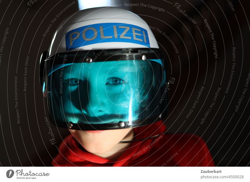 Boy playing with police helmets and blue visor Boy (child) Police Force Gun sight Blue Scare game children Infancy fun Playing free time Red Child Joy Dress up