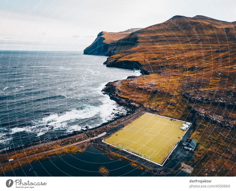 Football pitch at the edge of the sea in the Faroe Islands traditionally Outdoors spectacular rocky naturally harmony Weather Rock Hill Environment Rural