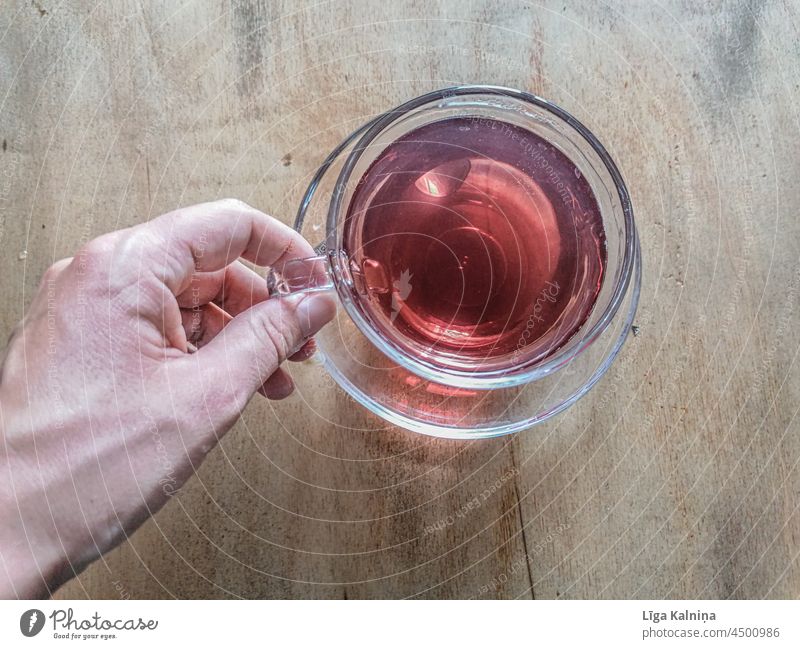 hand picking up red tea within cup Tea Beverage Healthy Colour photo Herb tea Studio shot Design Style Cup Herbs and spices Healthy Eating Alternative medicine