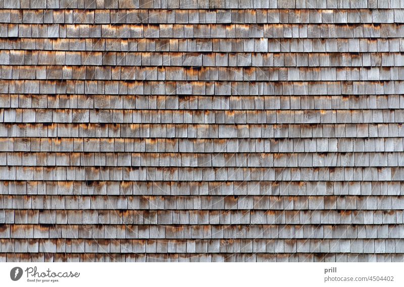 wooden shingles clapboards weatherboarded full frame background backdrop weathered lots of rowed cladding covering pattern detail architecture building old