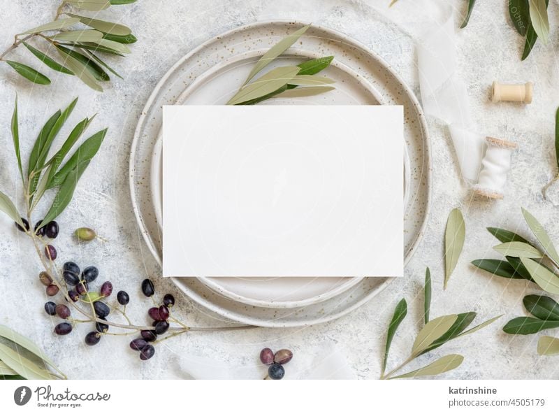 Wedding Table place with a card decorated with olive branches Card Blank mockup plate leaf fruit invitaion White green Leaves Mediterranean top view