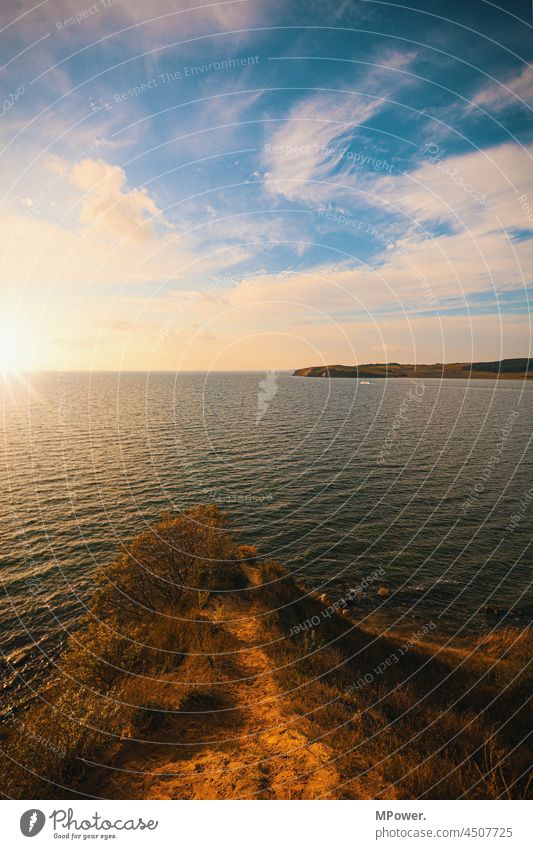 little bitch Rügen coast Ocean Baltic Sea Sunlight lens flair Waves Water Horizon Far-off places Vacation & Travel Deserted Cliff Clouds Longing Baltic island