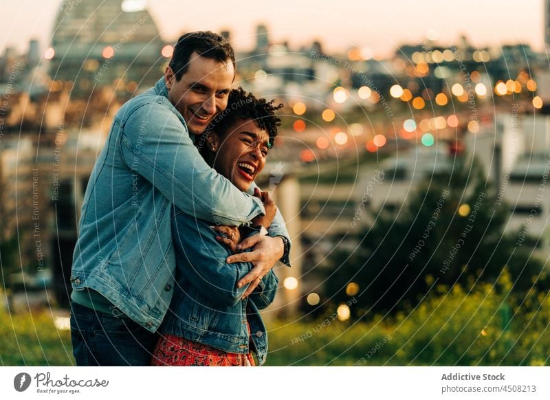 Happy couple hugging while spending time together in balcony at home - a  Royalty Free Stock Photo from Photocase