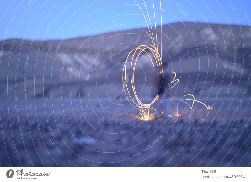 Iron wool circle drawing light fireworks. Burning Steel Wool spinning, Trajectories of burning sparks at night. Movement light effect, steel wool fire hoop. long exposure light painting, Pyrotechnic