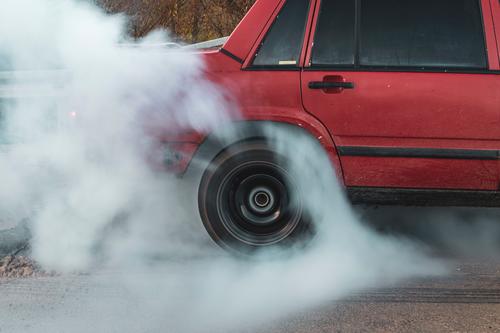 burn the tires car burnout red car tire burning tire in motion Colour photo rubber motion of a tire wheel Car tire driving Vehicle smoke cloud of smoke