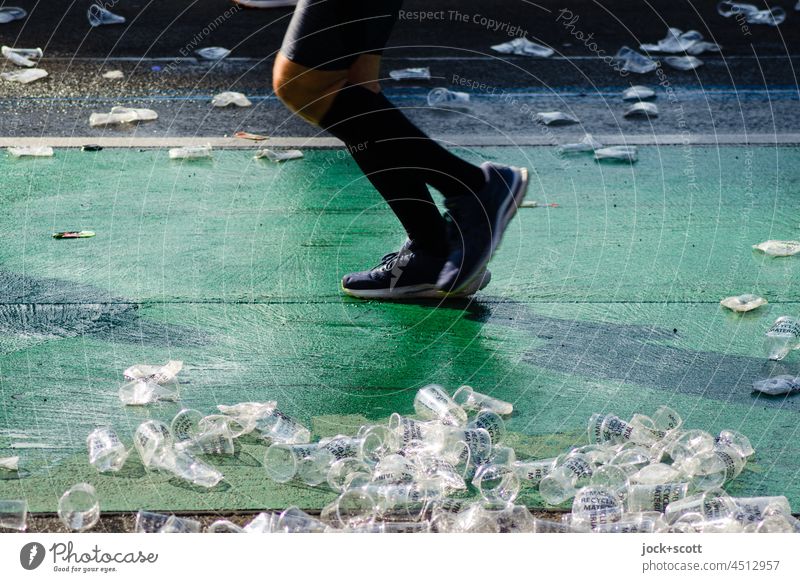 Few of 800,000 plastic cups at the marathon made from recycled PET Marathon Sports Street Fitness Runner Lifestyle Cycle path Plastic cup Trash jettisoned Legs