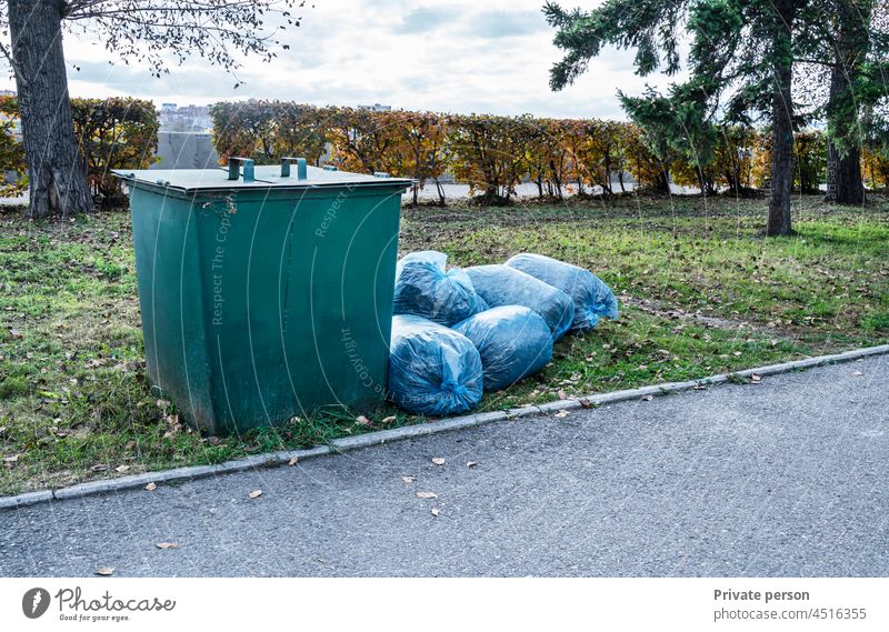 https://www.photocase.com/photos/4516355-garbage-container-and-big-pile-of-garbage-in-blue-bags-in-the-park-photocase-stock-photo-large.jpeg