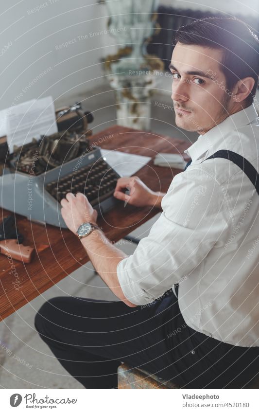 handsome journalist writing with retro typewriter work paper man business desk letter old vintage caucasian table background text office indoor texture culture