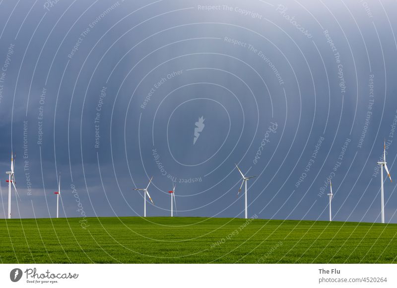 Wind turbines in a thunderstorm Pinwheel wind farm Energy Energy industry Energy crisis Wind energy plant Renewable energy Electricity Environmental protection