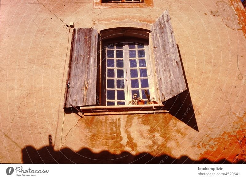 House wall with an old high window with shutter Window Shutter folding shutter House (Residential Structure) house facade Wall (barrier) Historic Old Retro