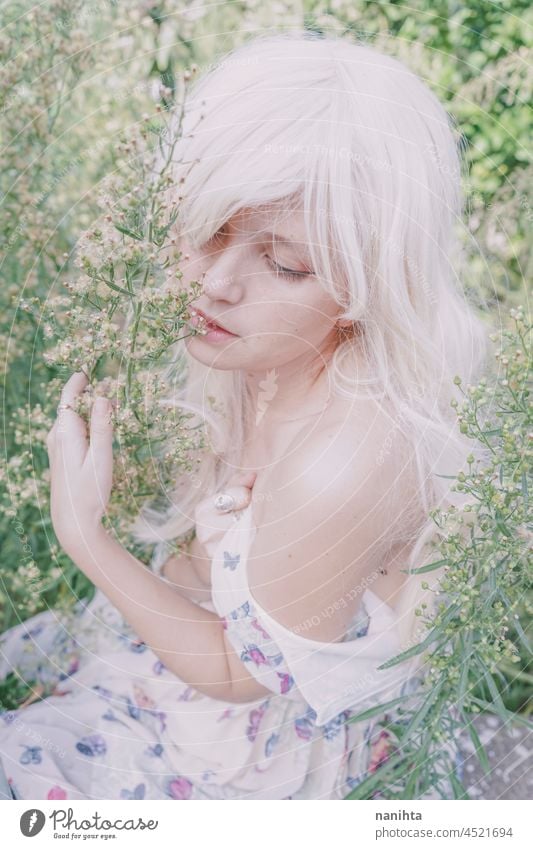 Artistic and reamy portrait of a woman surrouded by nature forest fantasy fairy delicate albino fairy tale feminine femininity long hair white caucasian pale