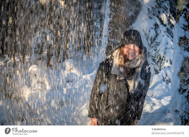 Young woman in snow flurry is happy Winter Nature Season Cold Frost Snow daylight Day Blue Brown White winter Forest Spruce Coniferous trees coniferous