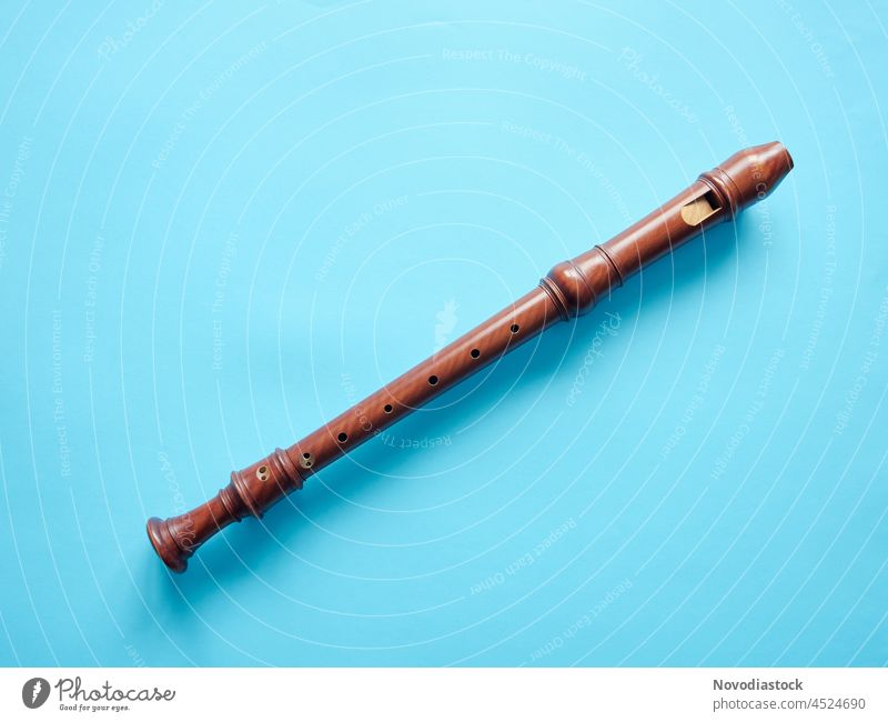 Baroque recorder isolated on blue background, with copy space flute instrument musical musical instrument education wooden one object no people nobody art