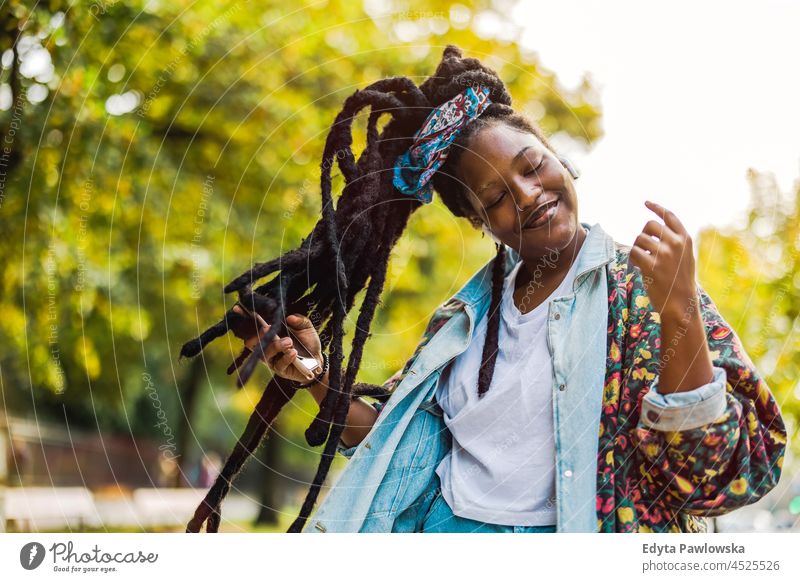 Young woman enjoying dancing and listening music outdoors unaltered natural real people authentic body inclusivity body positive one person hipster girl