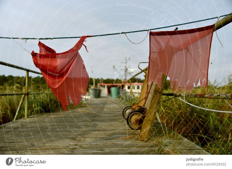 Red flags at the harbour Harbour Footbridge Flag cordon Wheelbarrow Sky Fishing port Fishery fishing coast Ocean Baltic Sea reed ton boat